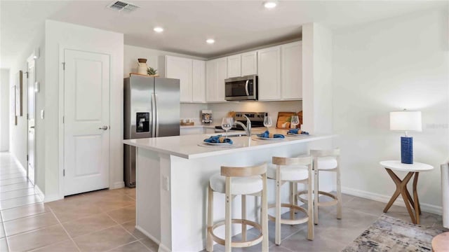 6591 SW 81st Loop, Ocala, FL 34476 - kitchen featuring a peninsula, light tile patterned flooring, stainless steel appliances, and visible vents
