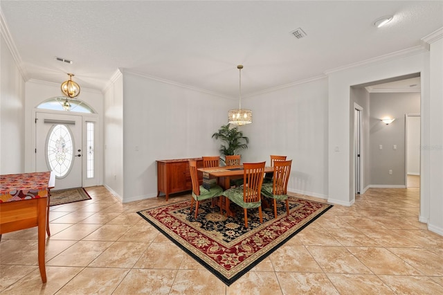 dining space with visible vents, ornamental molding, and an inviting chandelier