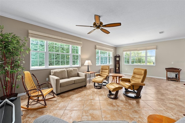 living area with plenty of natural light, crown molding, baseboards, and ceiling fan