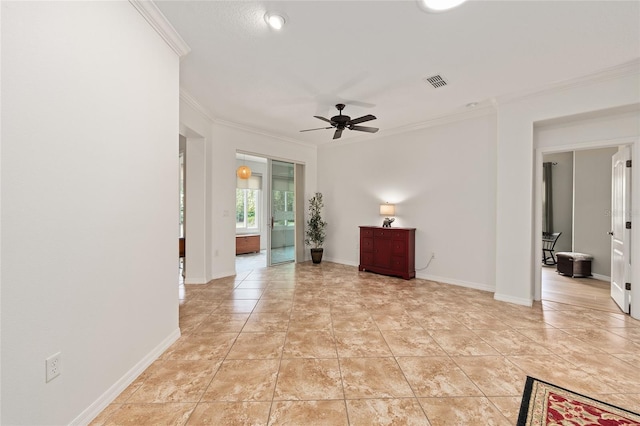 interior space with ceiling fan, baseboards, crown molding, and visible vents
