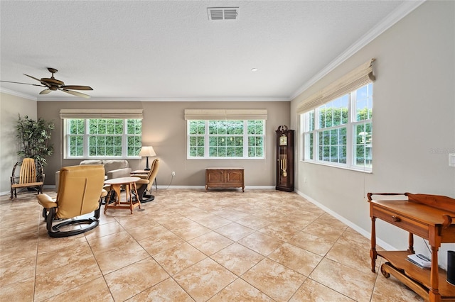 living area with visible vents, a wealth of natural light, and crown molding