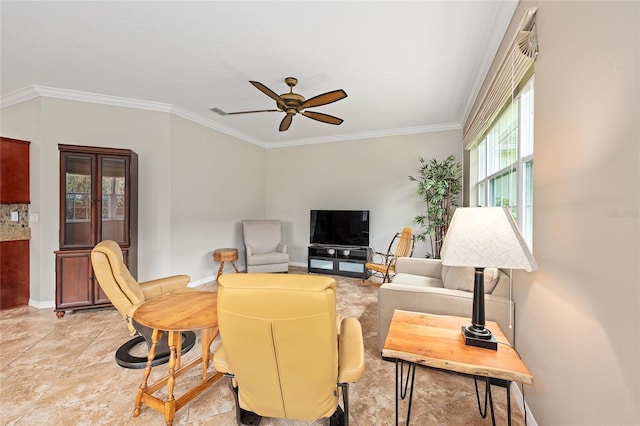 living area with ornamental molding, baseboards, and ceiling fan
