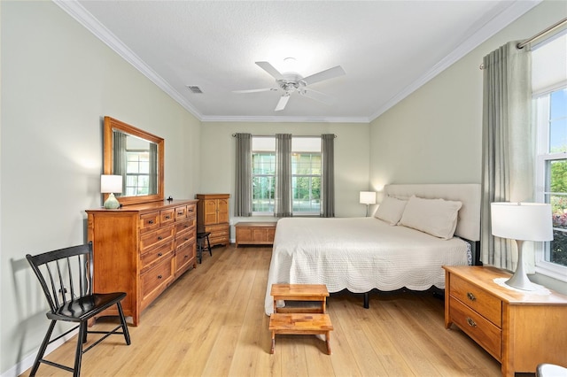 bedroom with multiple windows, crown molding, and light wood-style floors