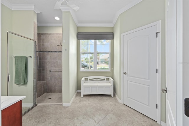 full bathroom featuring tiled shower, baseboards, tile patterned flooring, ceiling fan, and crown molding