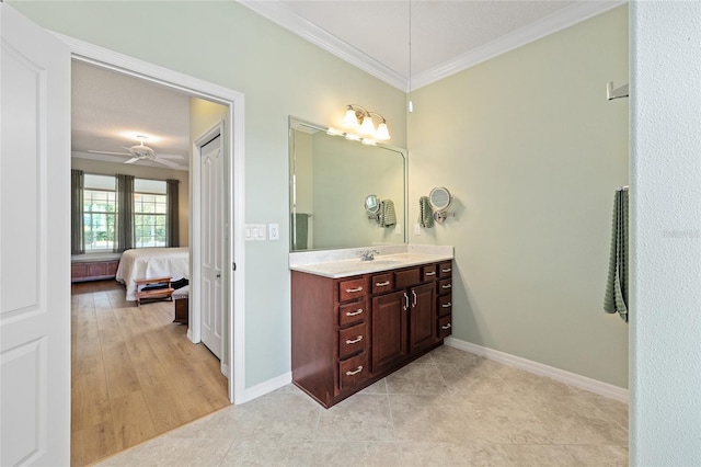bathroom with ceiling fan, vanity, ornamental molding, and ensuite bathroom