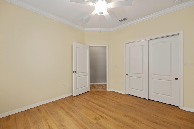 unfurnished bedroom with baseboards, ornamental molding, visible vents, and light wood-type flooring