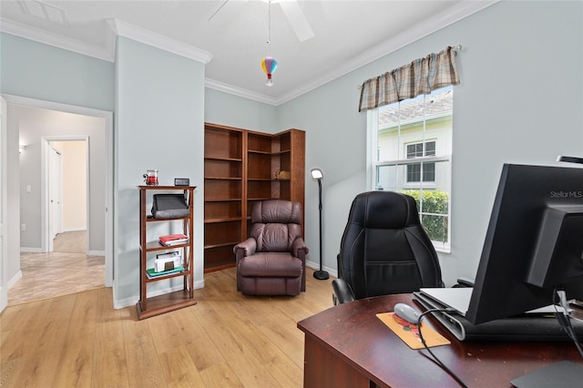 office space with a ceiling fan, crown molding, light wood-style flooring, baseboards, and visible vents