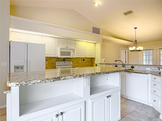 5327 SW 89th St, Ocala, FL 34476 - kitchen with decorative backsplash, white appliances, and lofted ceiling