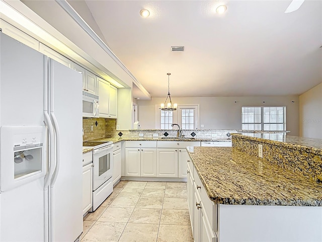 5327 SW 89th St, Ocala, FL 34476 - kitchen with a sink, white appliances, a peninsula, tasteful backsplash, and visible vents