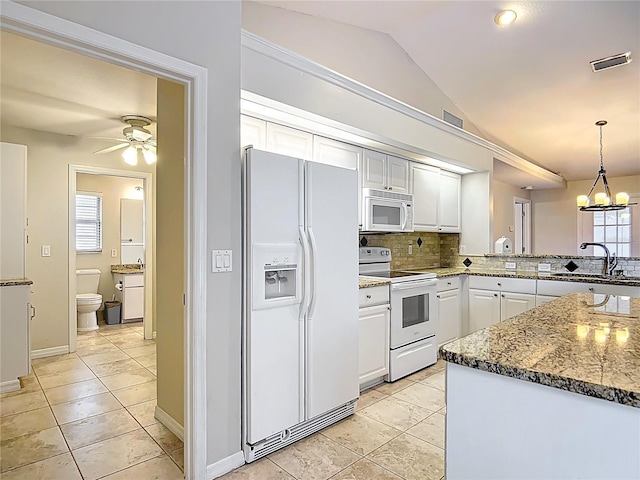 5327 SW 89th St, Ocala, FL 34476 - kitchen with backsplash, vaulted ceiling, a sink, ceiling fan with notable chandelier, and white appliances