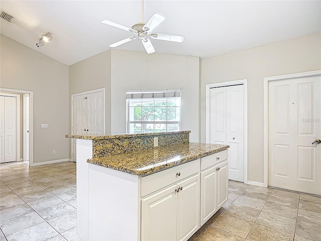 5327 SW 89th St, Ocala, FL 34476 - kitchen with a ceiling fan, visible vents, lofted ceiling, dark stone counters, and white cabinetry