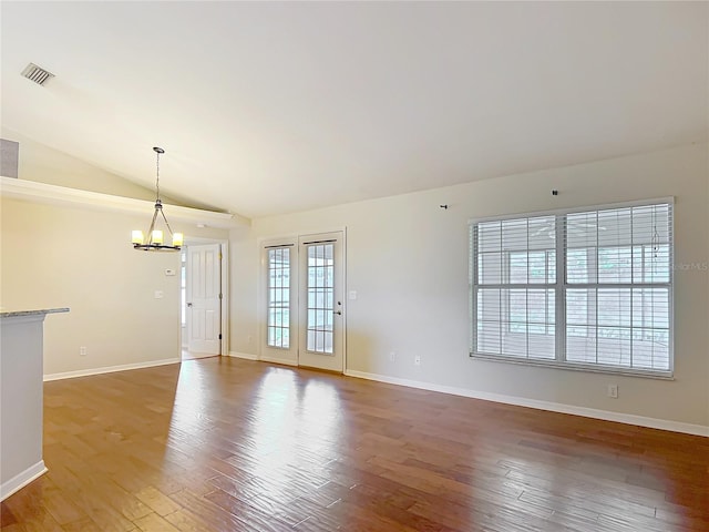 5327 SW 89th St, Ocala, FL 34476 - unfurnished living room with visible vents, a notable chandelier, wood finished floors, baseboards, and lofted ceiling
