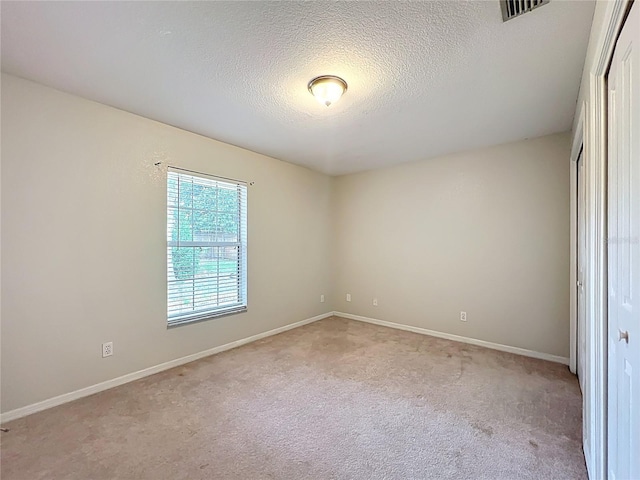 5327 SW 89th St, Ocala, FL 34476 - unfurnished bedroom with visible vents, a closet, light carpet, baseboards, and a textured ceiling