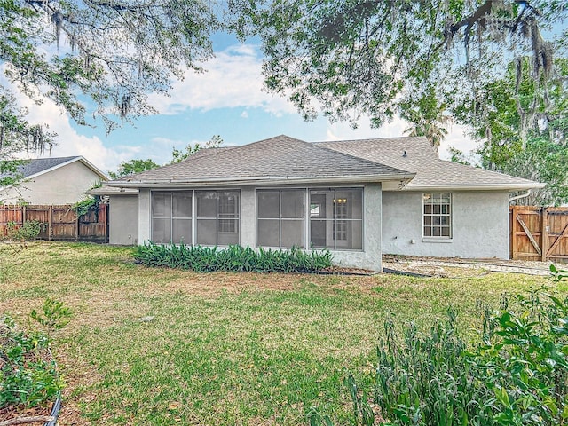 5327 SW 89th St, Ocala, FL 34476 - back of house featuring a sunroom, a fenced backyard, a yard, a shingled roof, and stucco siding
