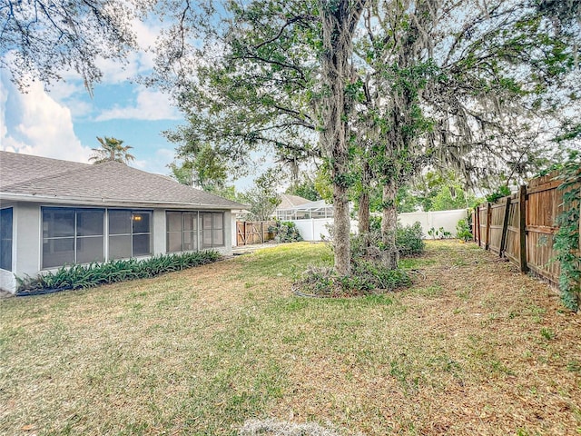 5327 SW 89th St, Ocala, FL 34476 - view of yard featuring a fenced backyard and a sunroom