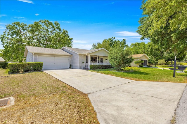 10989 SW 86th Ave, Ocala, FL 34481 - ranch-style home with covered porch, concrete driveway, a front lawn, and a garage