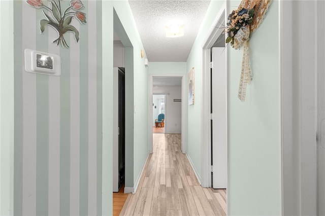 10989 SW 86th Ave, Ocala, FL 34481 - hallway with light wood-style floors, baseboards, and a textured ceiling