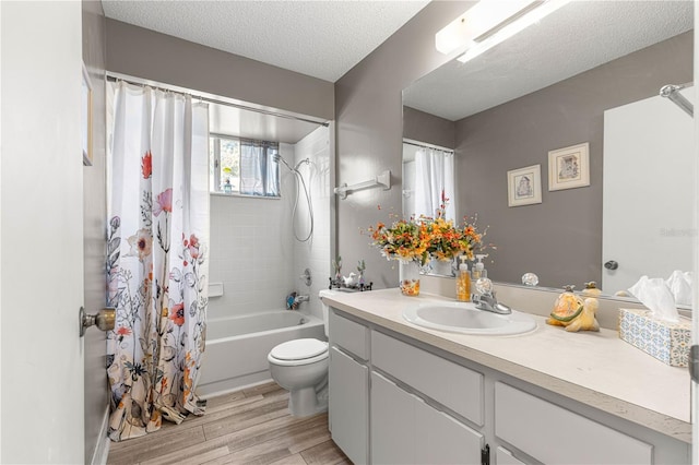 10989 SW 86th Ave, Ocala, FL 34481 - bathroom with a textured ceiling, shower / bath combo with shower curtain, toilet, wood finished floors, and vanity