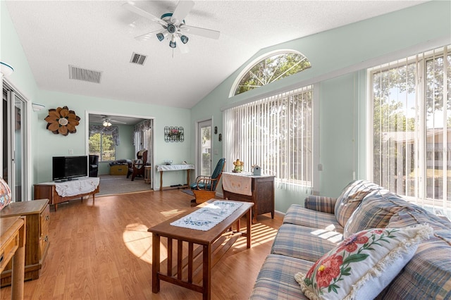10989 SW 86th Ave, Ocala, FL 34481 - living room featuring wood finished floors, visible vents, ceiling fan, and vaulted ceiling