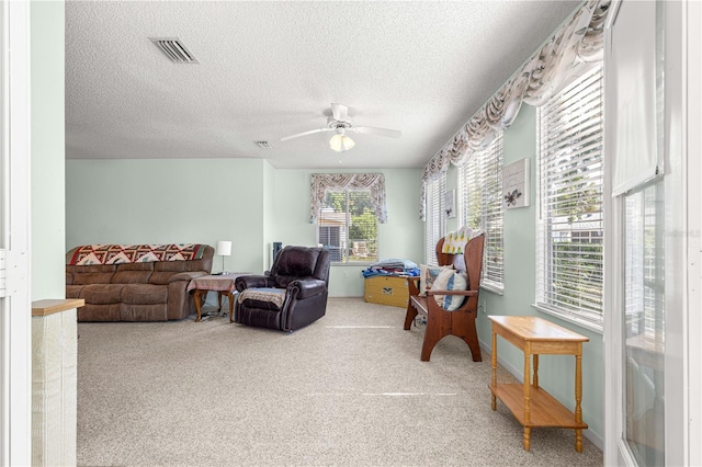 10989 SW 86th Ave, Ocala, FL 34481 - living area featuring carpet, visible vents, a ceiling fan, and a textured ceiling
