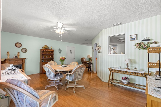 10989 SW 86th Ave, Ocala, FL 34481 - dining room featuring light wood-type flooring, a textured ceiling, ceiling fan, and visible vents