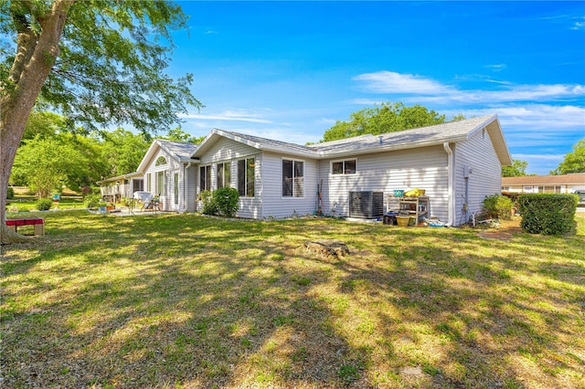 10989 SW 86th Ave, Ocala, FL 34481 - rear view of house featuring a patio, a yard, and central AC