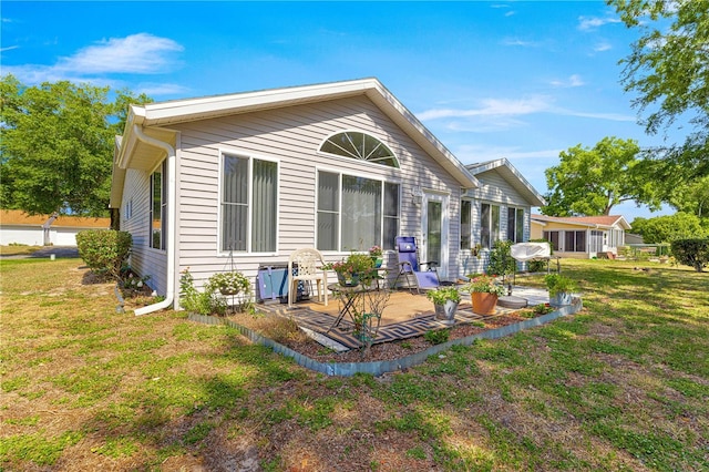 10989 SW 86th Ave, Ocala, FL 34481 - back of house with a lawn and a patio