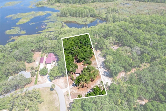 aerial view with a wooded view and a water view