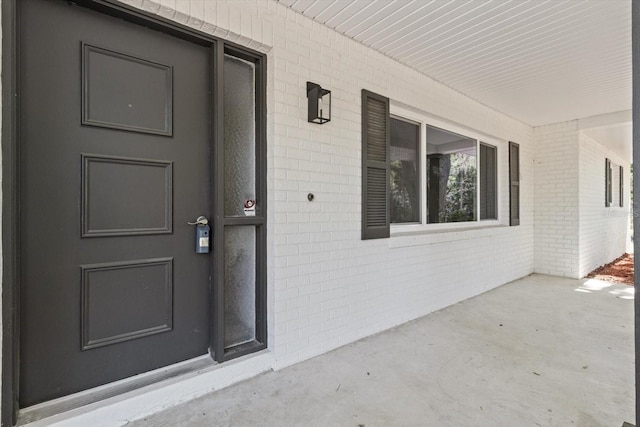 property entrance with brick siding