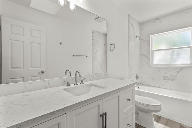 full bathroom featuring toilet, vanity, wood finished floors, and shower / tub combination