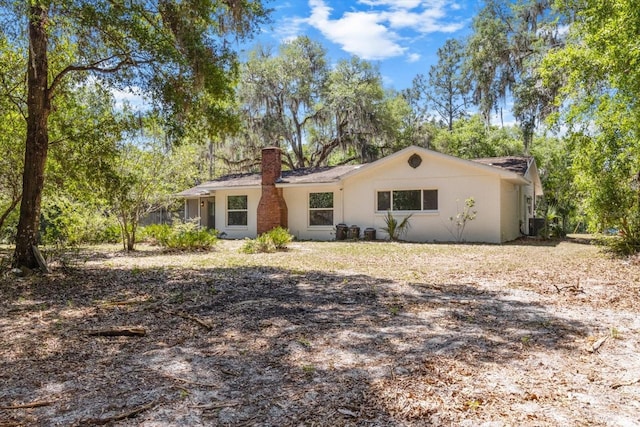 ranch-style home with a chimney