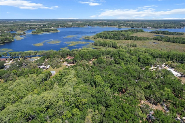 aerial view with a forest view and a water view