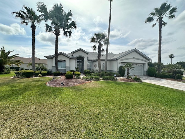 view of front of home featuring stucco siding, an attached garage, driveway, and a front yard