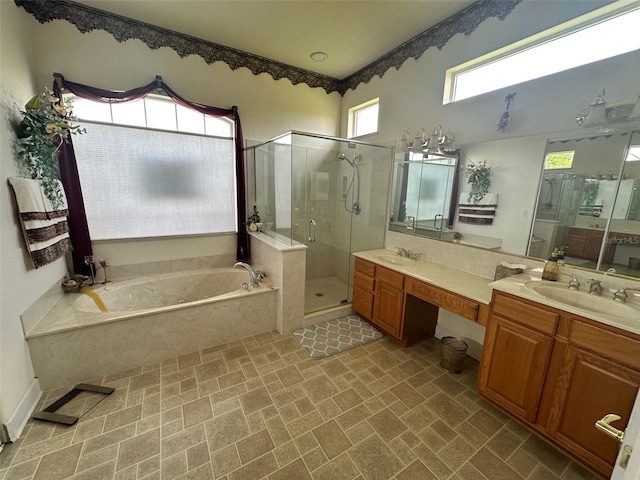 bathroom featuring a shower stall, a bath, a sink, and double vanity