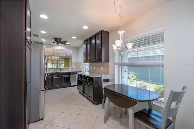 7249 SW 93rd Ave, Ocala, FL 34481 - kitchen featuring light tile patterned flooring, an inviting chandelier, stainless steel appliances, backsplash, and visible vents