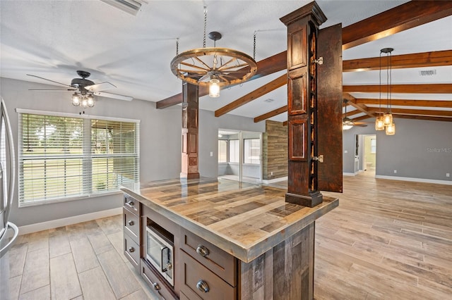 kitchen with ceiling fan, butcher block countertops, lofted ceiling with beams, and baseboards