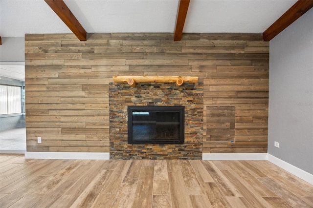 unfurnished living room featuring wood walls and wood finished floors
