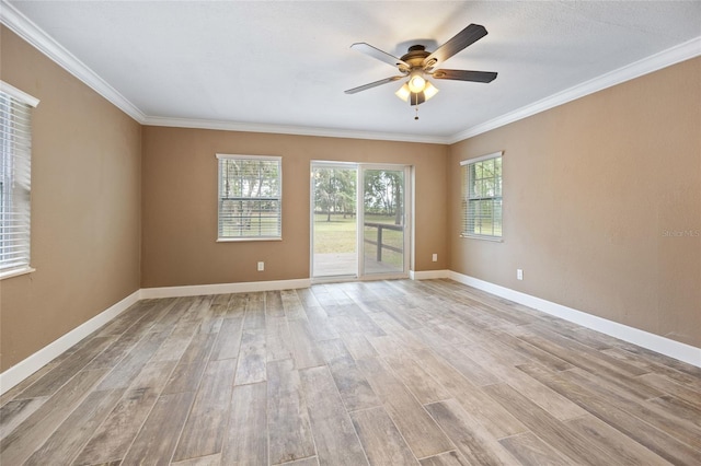 unfurnished room featuring crown molding, light wood-type flooring, baseboards, and ceiling fan