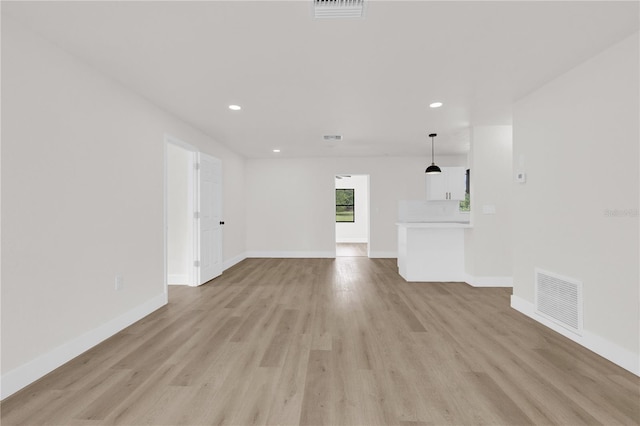 3807 SW 143rd Lane Rd, Ocala, FL 34473 - unfurnished living room featuring light wood-type flooring, baseboards, and recessed lighting