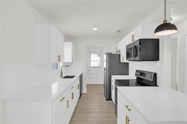 3807 SW 143rd Lane Rd, Ocala, FL 34473 - kitchen featuring stainless steel appliances, a sink, tasteful backsplash, light wood-style floors, and recessed lighting