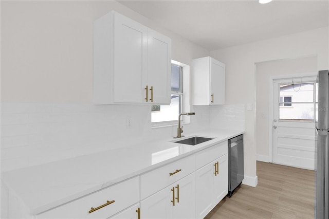 3807 SW 143rd Lane Rd, Ocala, FL 34473 - kitchen with a sink, stainless steel appliances, light countertops, and white cabinets
