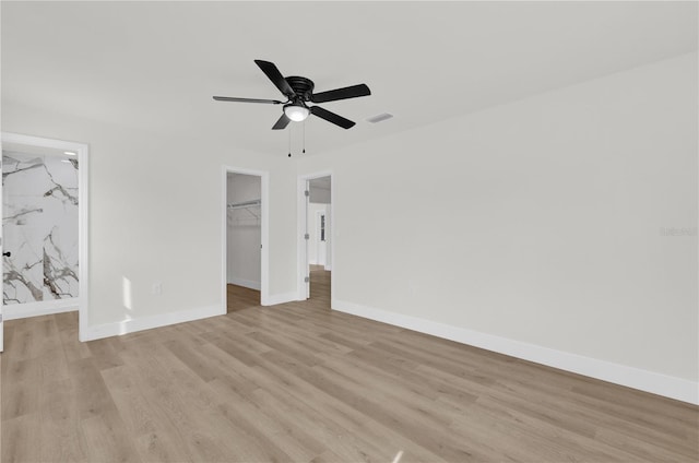 3807 SW 143rd Lane Rd, Ocala, FL 34473 - unfurnished bedroom featuring light wood-type flooring, baseboards, a walk in closet, and a closet