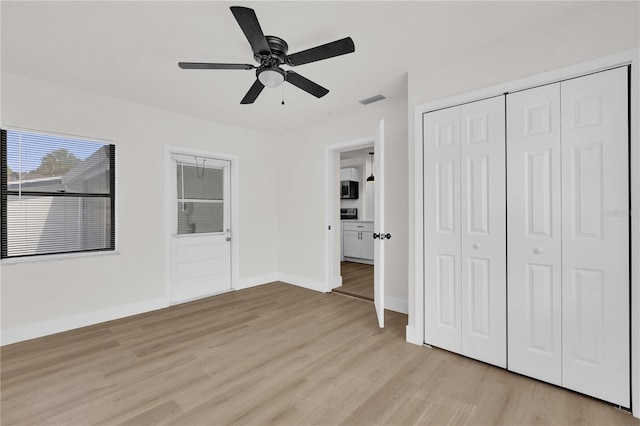 3807 SW 143rd Lane Rd, Ocala, FL 34473 - unfurnished bedroom featuring light wood finished floors, a closet, a ceiling fan, and baseboards
