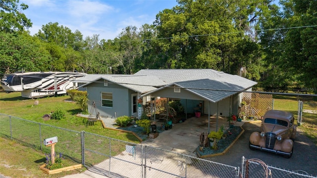 ranch-style home with a gate, a fenced front yard, and concrete driveway