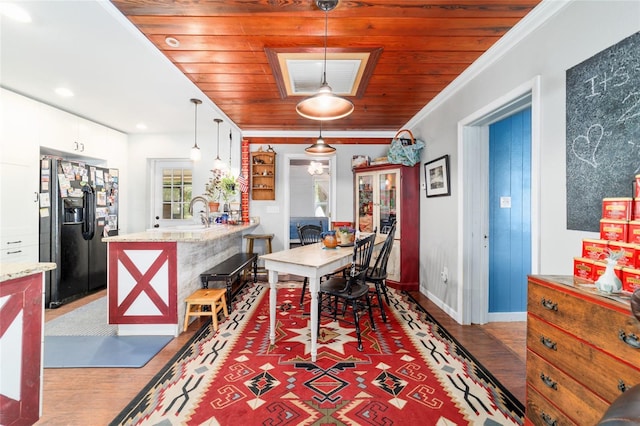 dining room with wooden ceiling, baseboards, ornamental molding, and wood finished floors