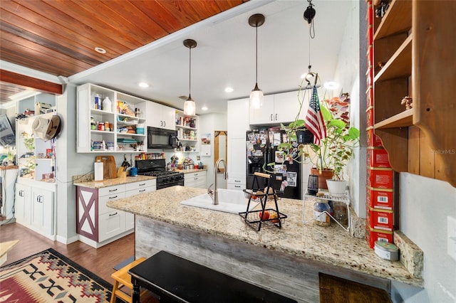 kitchen featuring a peninsula, a sink, white cabinetry, open shelves, and black appliances