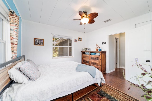 bedroom with visible vents, wood finished floors, and ceiling fan