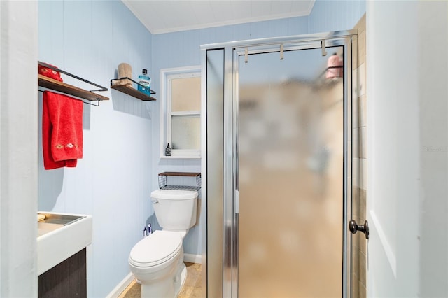 bathroom with a stall shower, toilet, vanity, and crown molding
