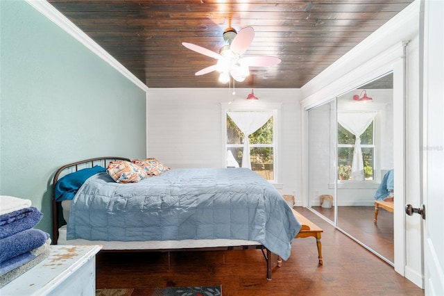 bedroom with wood ceiling, ornamental molding, and multiple windows