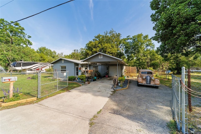 bungalow-style home with a carport, a gate, concrete driveway, fence private yard, and a front yard